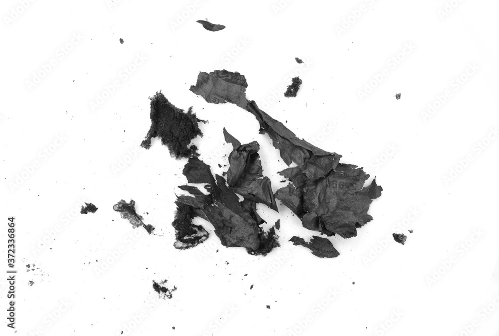 Obraz premium Burnt paper on a white background. The ashes of the paper. Charred paper scraps.