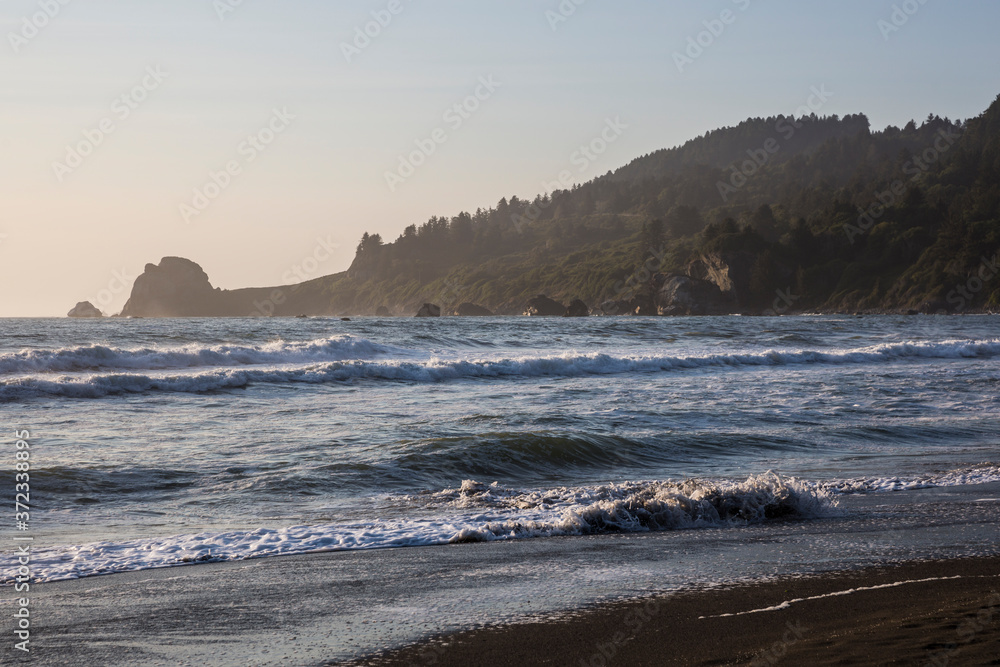 Beautiful sunset with splashing waves on the beach of False Klamath Cove in Redwood National Park (California). Beautiful sunset with splashing waves on the beach of False Klamath Cove in Redwood National Park (California).