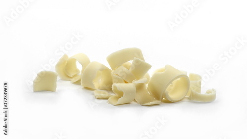 Chocolate roll. White Chocolate Curls Isolated On White Background. Group of chocolate shavings. 