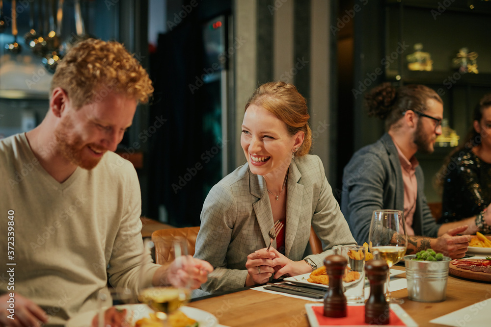 Friends sitting in restaurant and having dinner. Friends sitting in restaurant and having dinner.