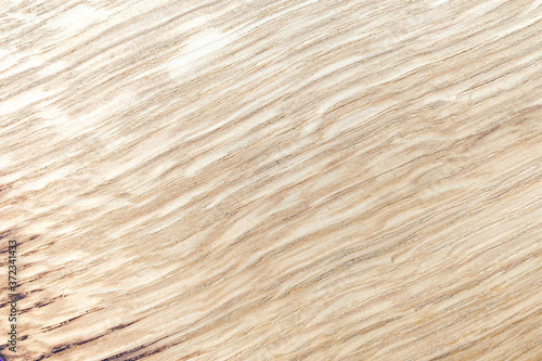 A light background of wood scorched on the edge. Texture, diagonal, soft wavy lines. High quality photo