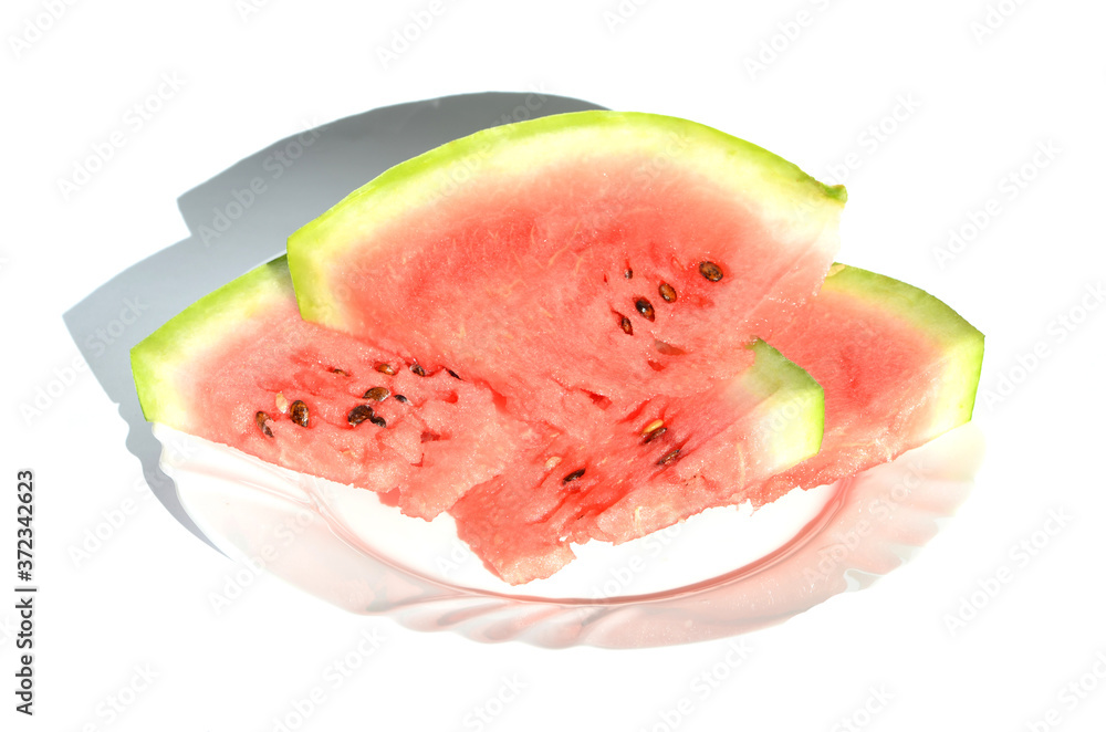Ripe watermelon pieces on the plate isolated on white, delicious berry Ripe watermelon pieces on the plate isolated on white, delicious berry