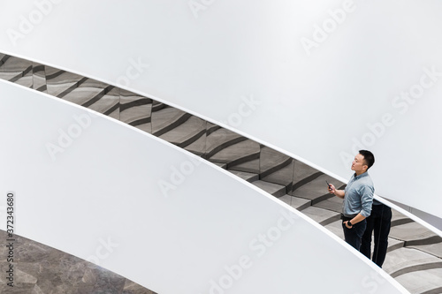 Businessman walking in office building photo