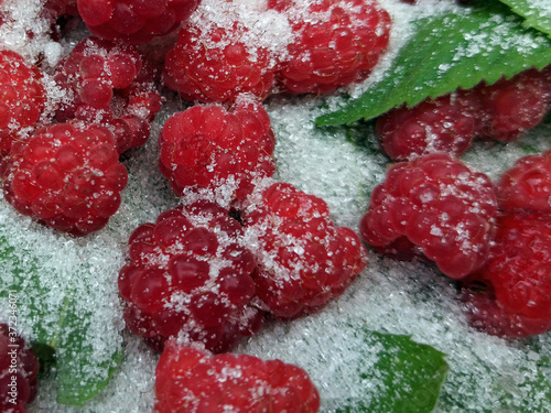 Obraz na płótnie photo of raspberries and mint leaves with white sugar. ingredients for mojito. Top view w salonie