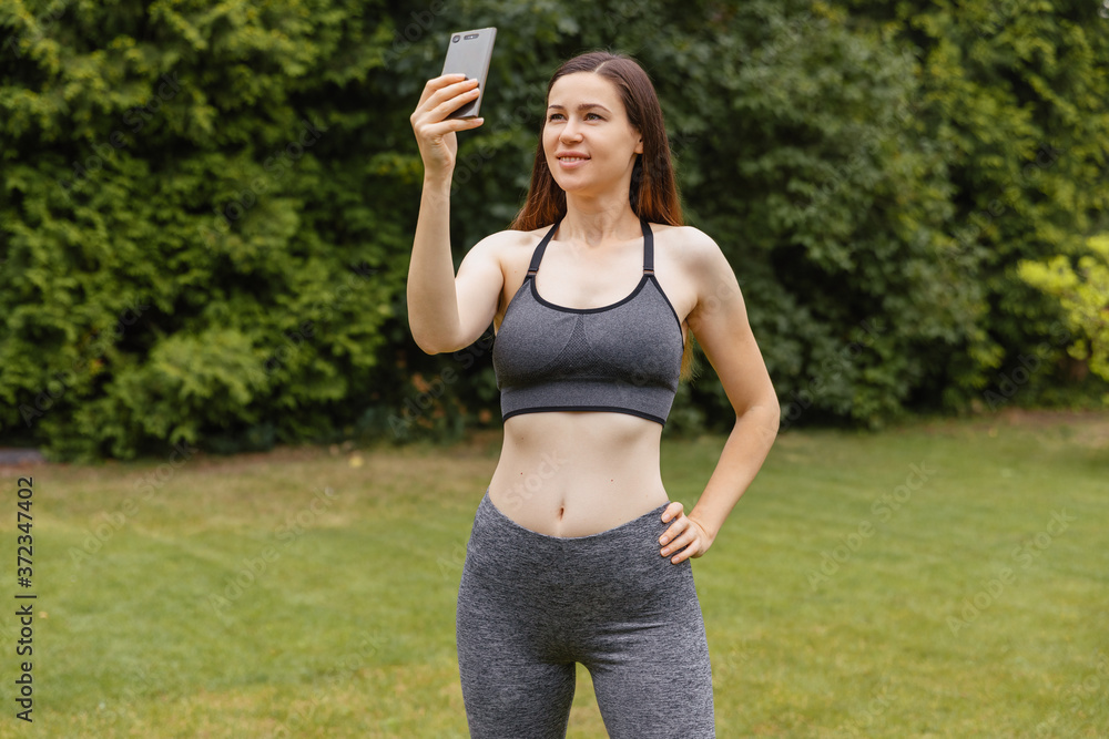 girl in sportswear takes selfie in the garden girl in sportswear takes selfie in the garden