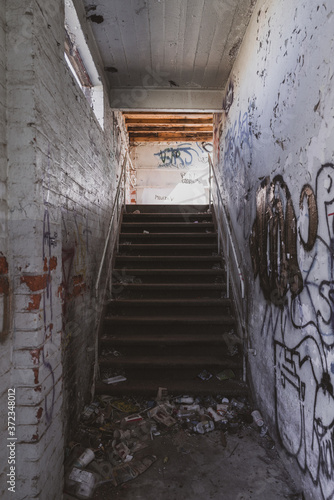 Concrete stairwell with rubbish and graffiti photo