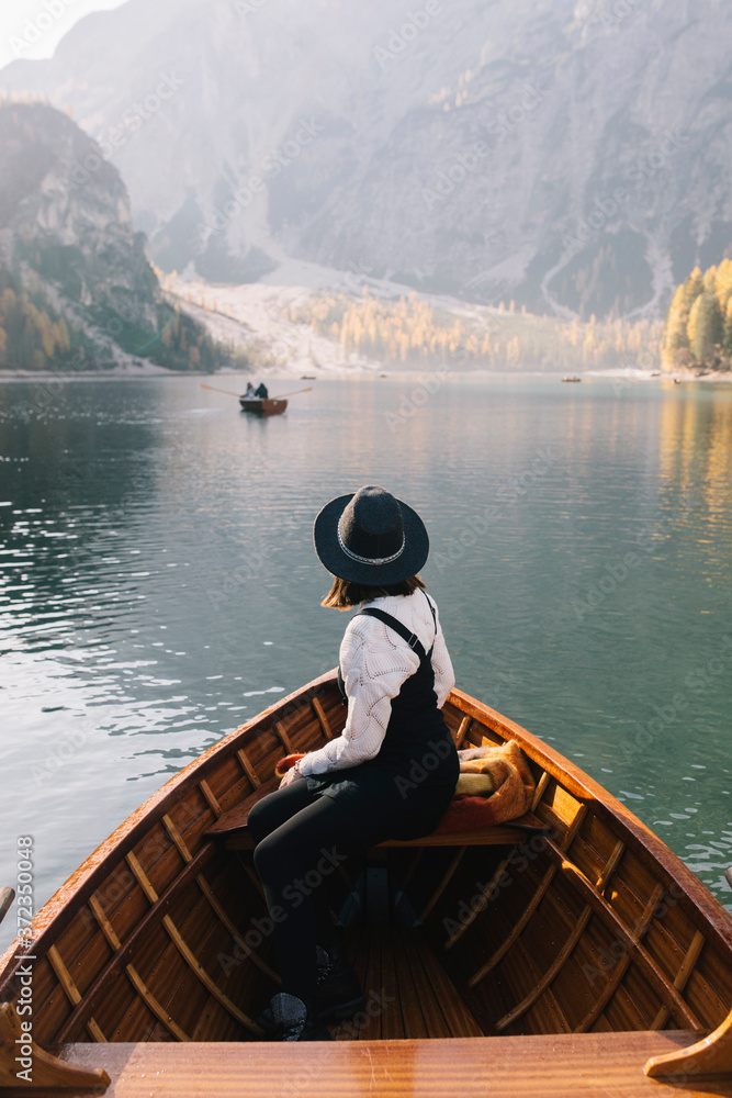 Young woman in a wooden boat in Lake Braies Young woman in a wooden boat in Lake Braies