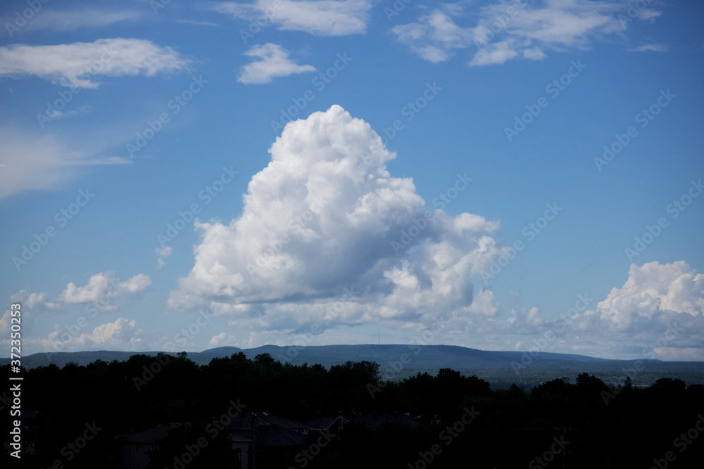 Large white, puffy clouds in sky during the day Large white, puffy clouds in sky during the day