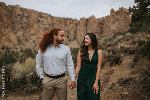 Happy Couple Holding Hands in Desert photo