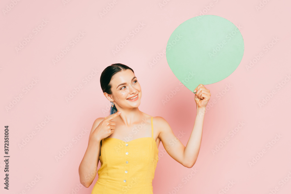 brunette young woman with green blank speech bubble on pink brunette young woman with green blank speech bubble on pink