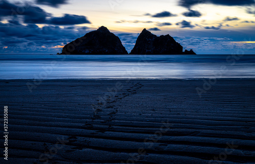 Gull rocks at sunset in Hollywell Bay in Cornwall photo