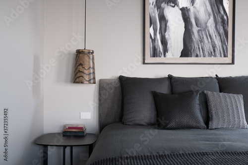 Styled bedroom with artwork and grey tonea photo