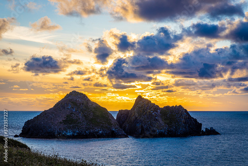 Gull rocks at sunset in Hollywell Bay in Cornwall photo