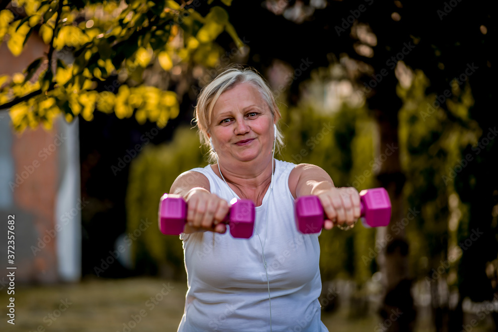 Senior woman working out with a dumbbells Senior woman working out with a dumbbells