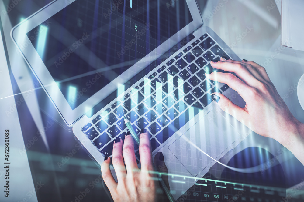Double exposure of woman hands working on computer and forex chart hologram drawing. Top View. Financial analysis concept. Double exposure of woman hands working on computer and forex chart hologram drawing. Top View. Financial analysis concept.