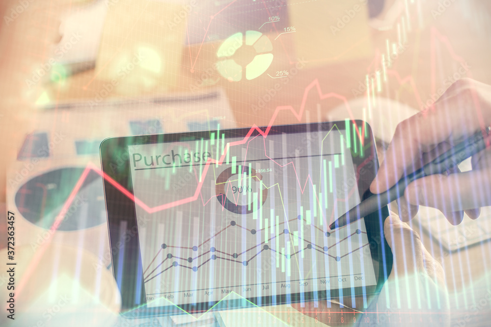 Fototapeta premium Double exposure of man's hands holding and using a phone and financial chart drawing. Market analysis concept.