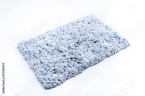 Flat lay, blue navy color of microfiber bath mat isolated on white background