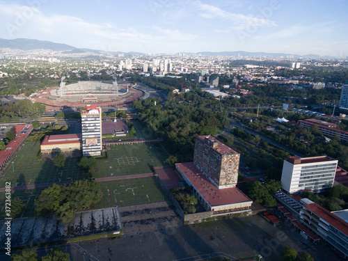 Vista aérea del Campus de la Universidad Nacional Autónoma de México con el Estadio Olímpico y un cielo azul como fondo photo