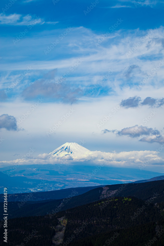 Aerial view of the mount Fuji with layered hills in the foreground. Portrait orientation.