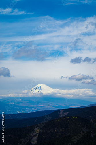 Aerial view of the mount Fuji with layered hills in the foreground. Portrait orientation.