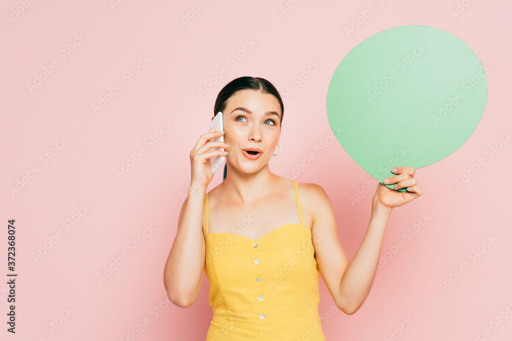 surprised brunette young woman with green blank speech bubble talking on smartphone on pink surprised brunette young woman with green blank speech bubble talking on smartphone on pink
