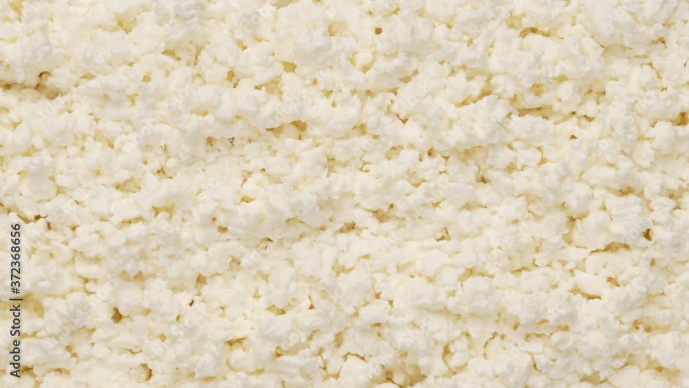 Crumbly cheese, top view. Healthy eating concept. The product is rich in protein. Vegetarianism. Crumbly cheese, top view. Healthy eating concept. The product is rich in protein. Vegetarianism.