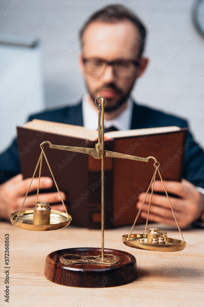 selective focus of golden scales near bearded lawyer reading book - obrazy, fototapety, plakaty 