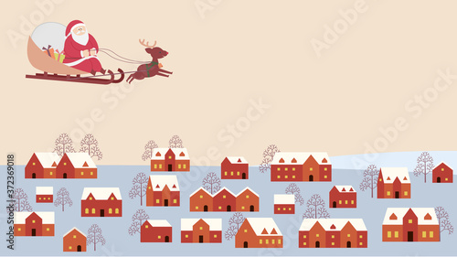 冬の町の空を飛ぶサンタクロース