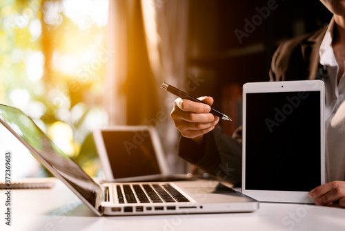 businesswoman using tablet screen mock up for your advertising text message,in the office blurred background view.