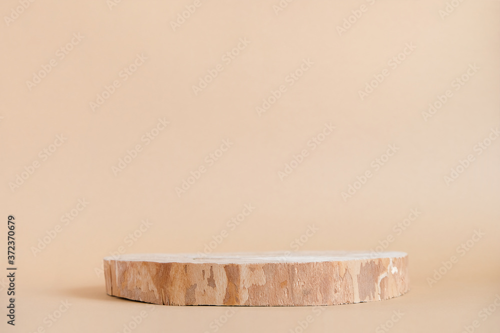 Round wooden saw cut cylinder shape on beige background abstract background. Minimal box and geometric podium. Scene with geometrical forms. Empty showcase for eco cosmetic product presentation Round wooden saw cut cylinder shape on beige background abstract background. Minimal box and geometric podium. Scene with geometrical forms. Empty showcase for eco cosmetic product presentation