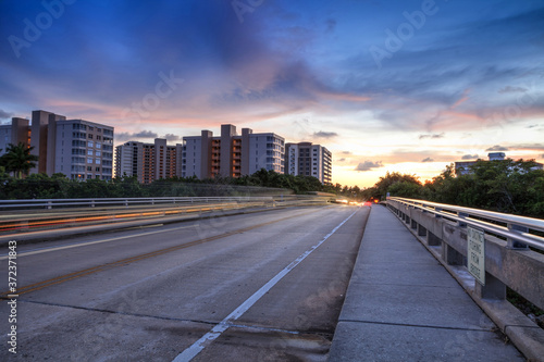 Light trails on the Overpass of Bluebill Avenue leading toward Delnor Wiggins State Park at sunset photo