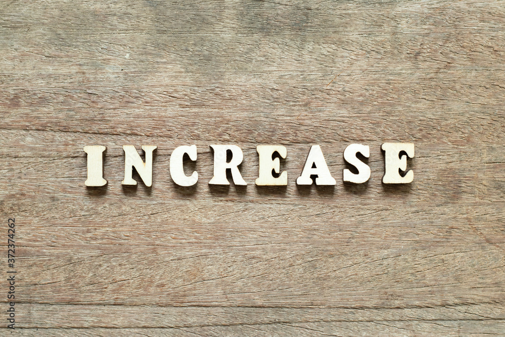 Alphabet letter block in word increase on wood background Alphabet letter block in word increase on wood background