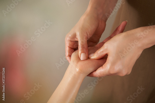 エステサロンで手のマッサージを受ける日本人女性