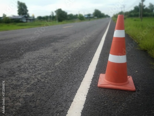 road construction with a red rubber cone in front © suwichan