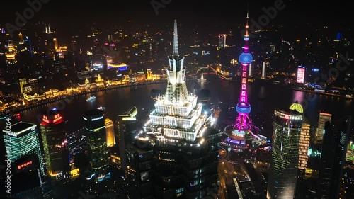 Shanghai - Night aerial city view with skyscrapers, Oriental Pearl Tower and river. 4K resolution time lapse photo