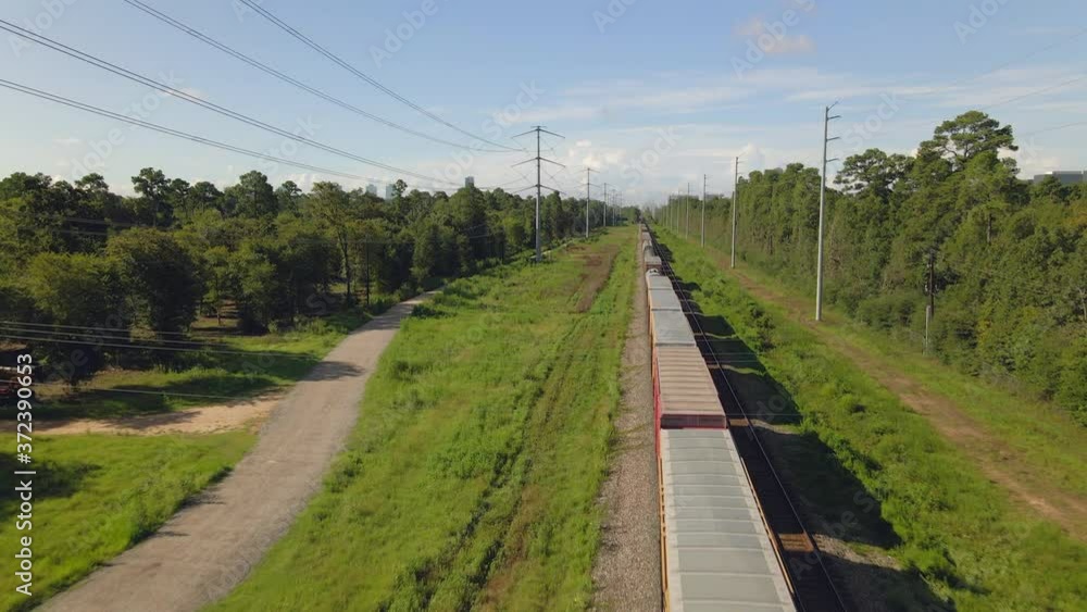 Aerial view of cargo train standing in forest near city Aerial view of cargo train standing in forest near city