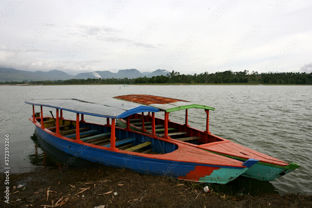 Twol boats in Situ Cileunca, Pangalengan, West Java, Indonesia. The atmosphere of Lake Cileunca with a row of boats leaning back