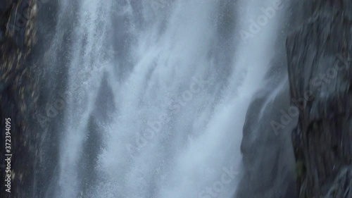 Close-up of how the water falls in the Venosc waterfall, French Alps. 4K photo