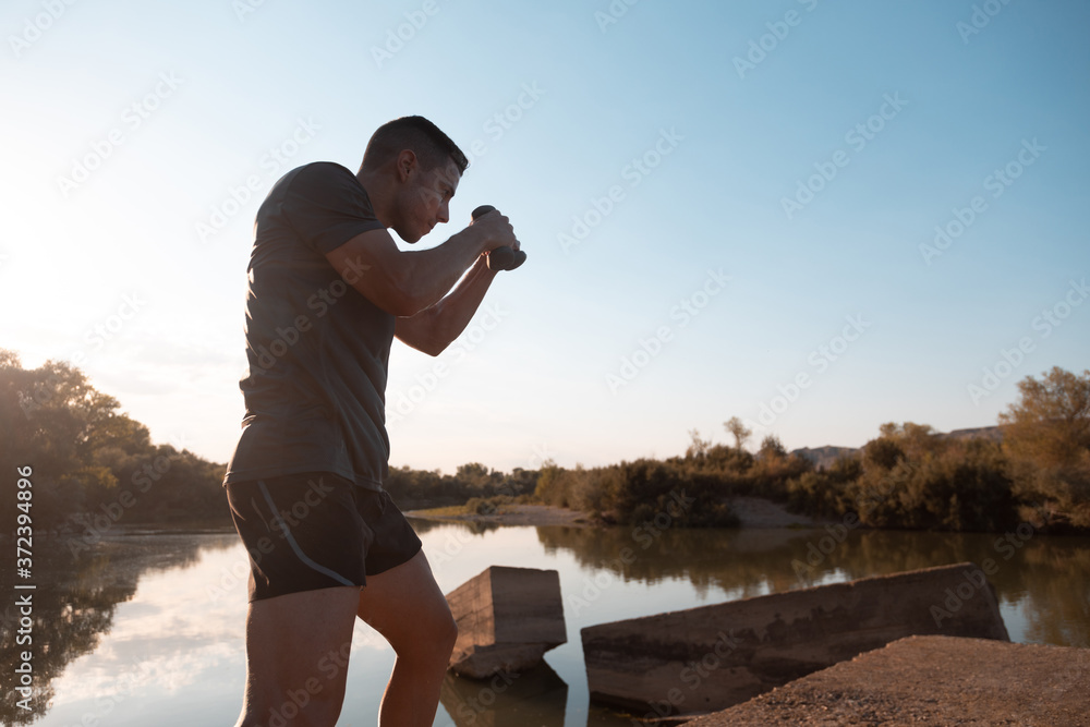 man training next to river