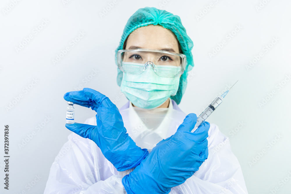 Doctor, scientist, researcher hand in blue gloves or protective suit preparing for human clinical injection trials vaccination covid-19 coronavirus vaccination Biological hazard concept. Doctor, scientist, researcher hand in blue gloves or protective suit preparing for human clinical injection trials vaccination covid-19 coronavirus vaccination Biological hazard concept.