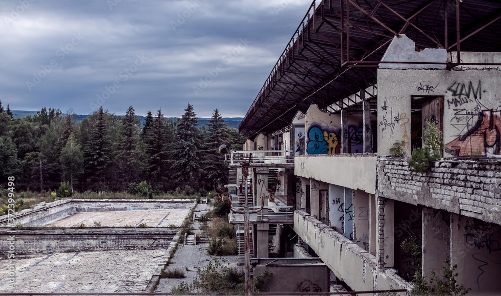 Abandoned destroyed building against the background of the forest. Abandonment on light background. Old grunge background. Architecture concept. Building architecture exterior. Stone wall background Abandoned destroyed building against the background of the forest. Abandonment on light background. Old grunge background. Architecture concept. Building architecture exterior. Stone wall background