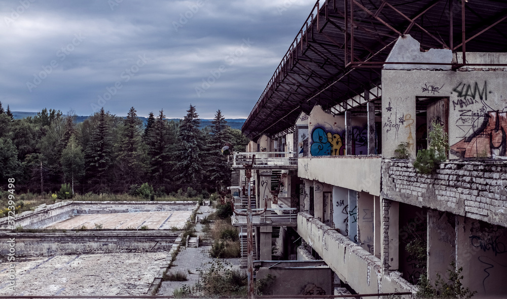 Abandoned destroyed building against the background of the forest. Abandonment on light background. Old grunge background. Architecture concept. Building architecture exterior. Stone wall background