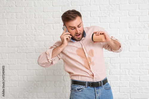 Stressed young man with cof...
