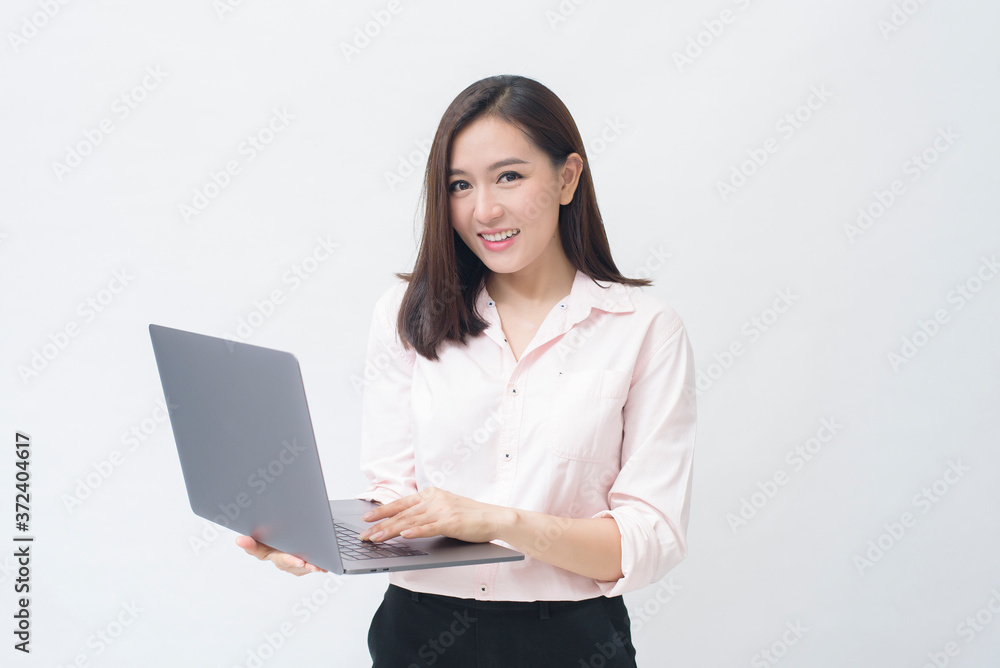 An asian woman is holding laptop computer on white Studio background An asian woman is holding laptop computer on white Studio background