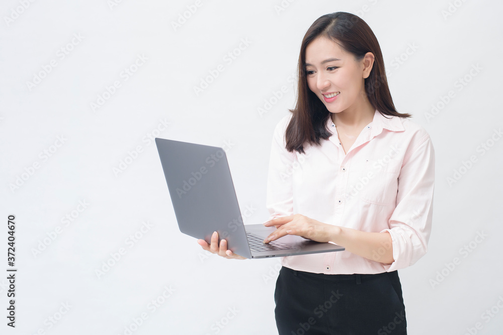 An asian woman is holding laptop computer on white Studio background An asian woman is holding laptop computer on white Studio background
