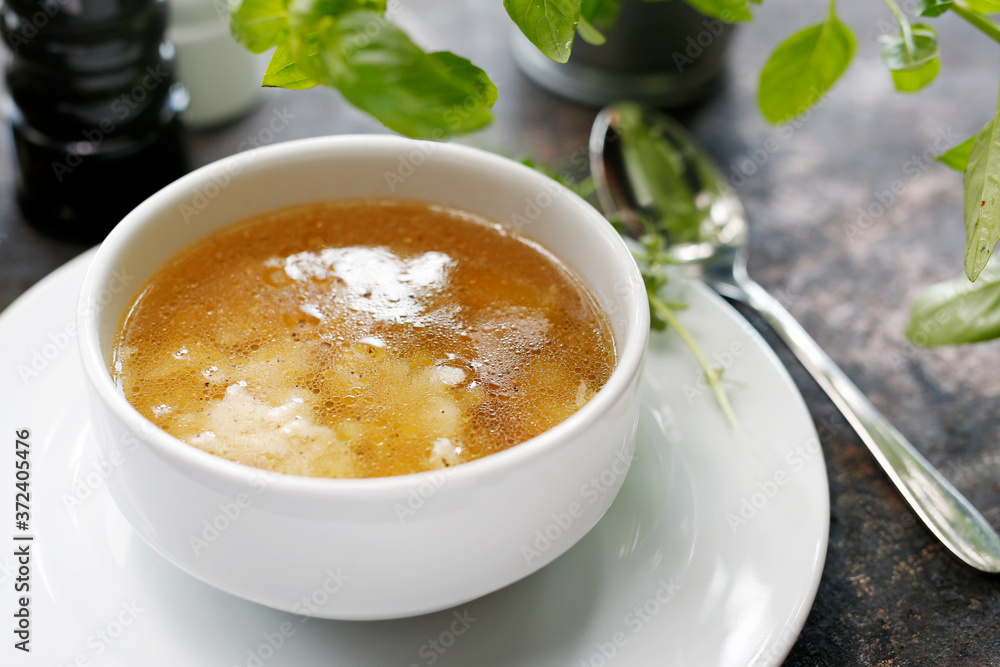 Homemade chicken broth with noodles. Appetizing soup. Suggestion to serve the dish. Culinary photography. Homemade chicken broth with noodles. Appetizing soup. Suggestion to serve the dish. Culinary photography.