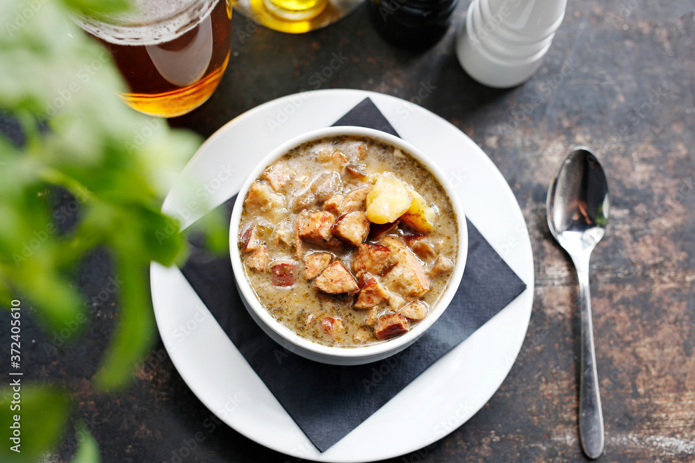 Traditional Polish sour rye soup with sausage and potatoes. Appetizing soup. Suggestion to serve the dish. Culinary photography. Traditional Polish sour rye soup with sausage and potatoes. Appetizing soup. Suggestion to serve the dish. Culinary photography.