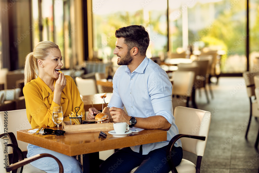 Smiling couple communicating during a lunch in a restaurant.