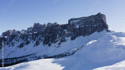 Wallpaper Mural Breathtaking bird's eye view of high mountain rocky peaks. Aerial scenery view of group of people trekking and climbs a hill covered with white snow. active recreation and travel to Alps in winter 
 Torontodigital.ca