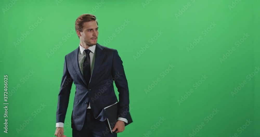 Businessman in a suit, confused person enters the frame and leaves the field of view, emotions, man holds a folder with documents in his hands, chroma key background. Businessman in a suit, confused person enters the frame and leaves the field of view, emotions, man holds a folder with documents in his hands, chroma key background.